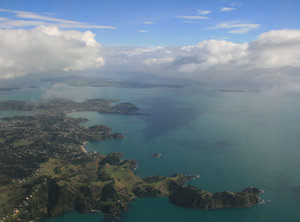 Auckland Aerial: View flying into Auckland, New Zealand, with Mt. Rangitoto in the distance.