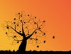 Autumn Sunset: Abstract swirly tree with autumn leaves and sunset orange background.