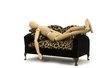 Zonked: Wooden artist's model reclining on a sofa.