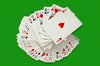 Playing Cards: A swirl of playing cards on green baize
