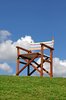 Canvas Garden Chair: Ordinary empty wooden framed garden chair against a blue sky