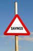 Savings Triangle Warning Sign: Red triangle savings warning sign against a blue sky background