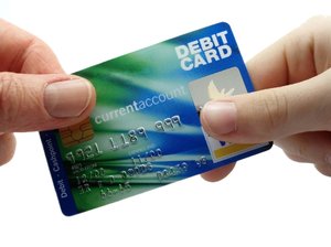Credit Card: Creit card being passed between two hands