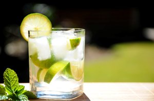 Lime Drink: Cool lime drink in a clear glass with mint in an outside setting