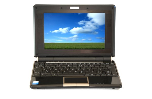 Laptop: Laptop with screen displaying blue sky field landscape (woodsy copyright image)