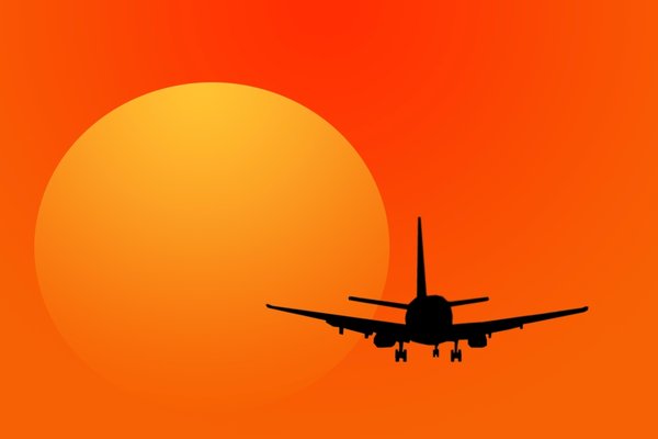 Jet Plane: Jet plane travel against a setting or rising sun
