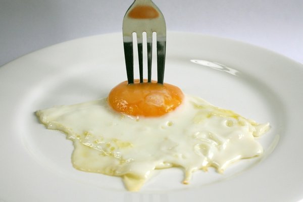 Fried Egg: A fried egg with a silver coloured eating fork