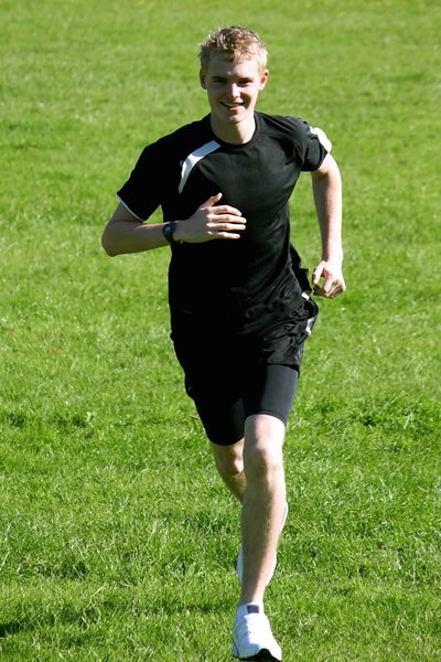 Jogger: Young male running in athlete's kit