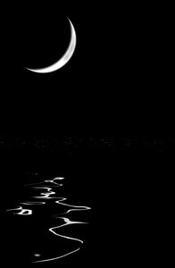 Crescent Moon Over Water: Glowing new or crescent moon over water at night. Plenty of copyspace. You may prefer this:  http://www.rgbstock.com/photo/nY4Is7U/Crescent+Moon+and+Star