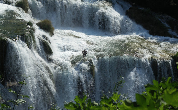 Man in waterfall Krka: A man standing in the middle of Krka waterfall in Croatia