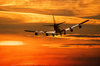 Airplane in sunset: romantic red sunset sky with airplane