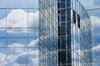 Clouds reflected in corporate : reflected clouds in office windows - larger file available