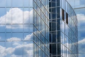 Clouds reflected in corporate : reflected clouds in office windows - larger file available