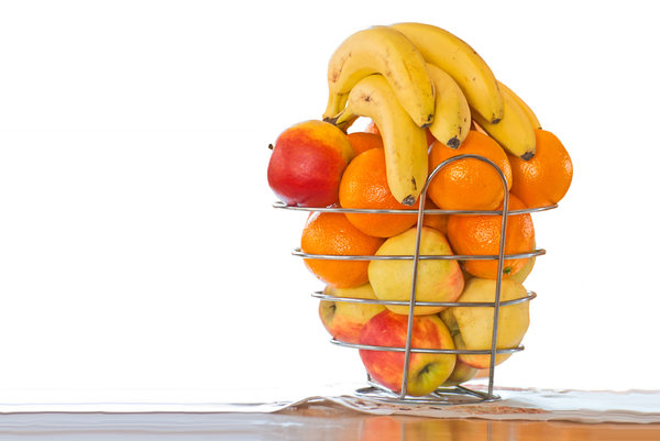Fruit basket: fruit basket against orange and white background